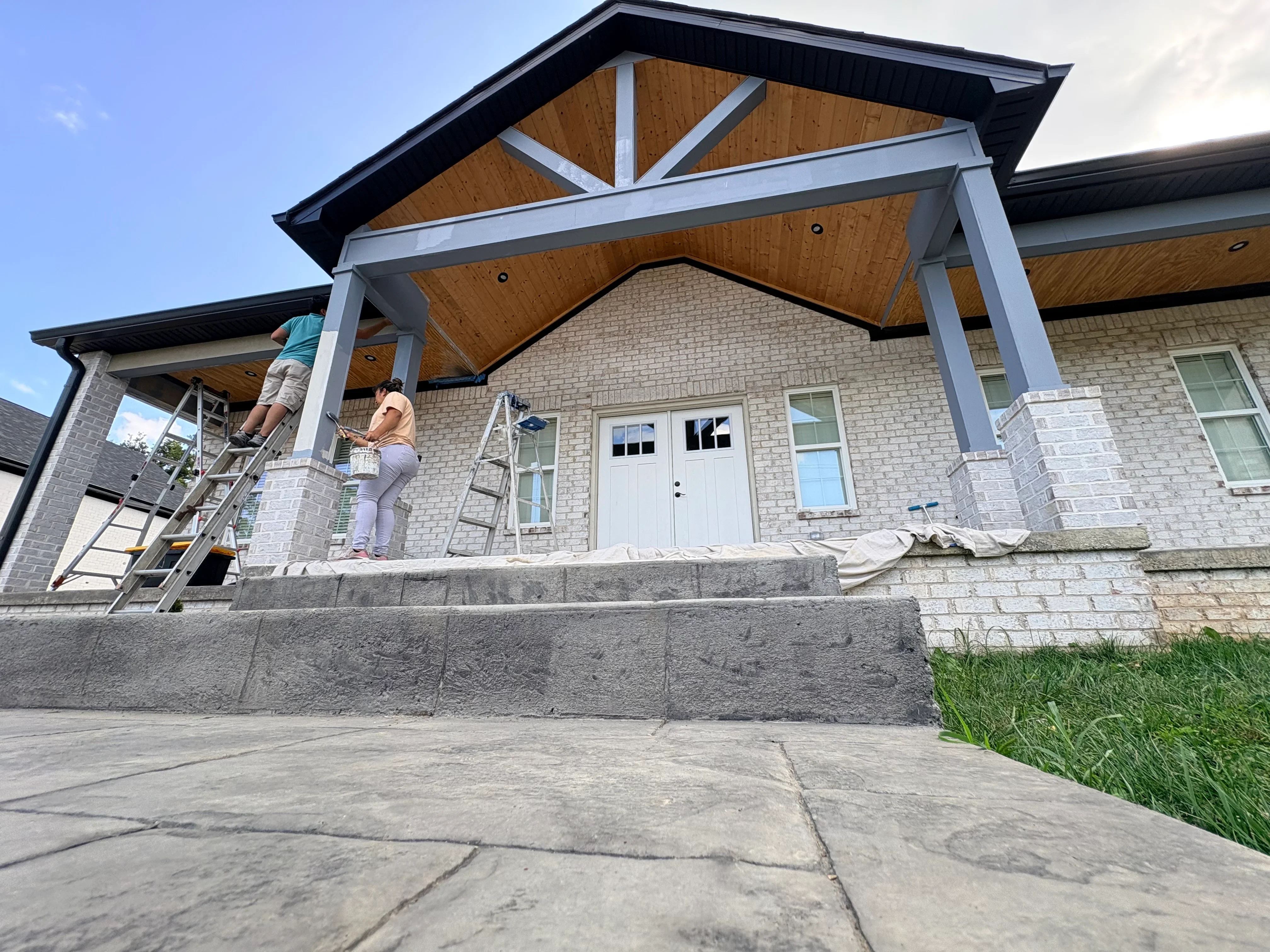 Polished epoxy concrete floor on new porch with steel columns and wooden ceiling details